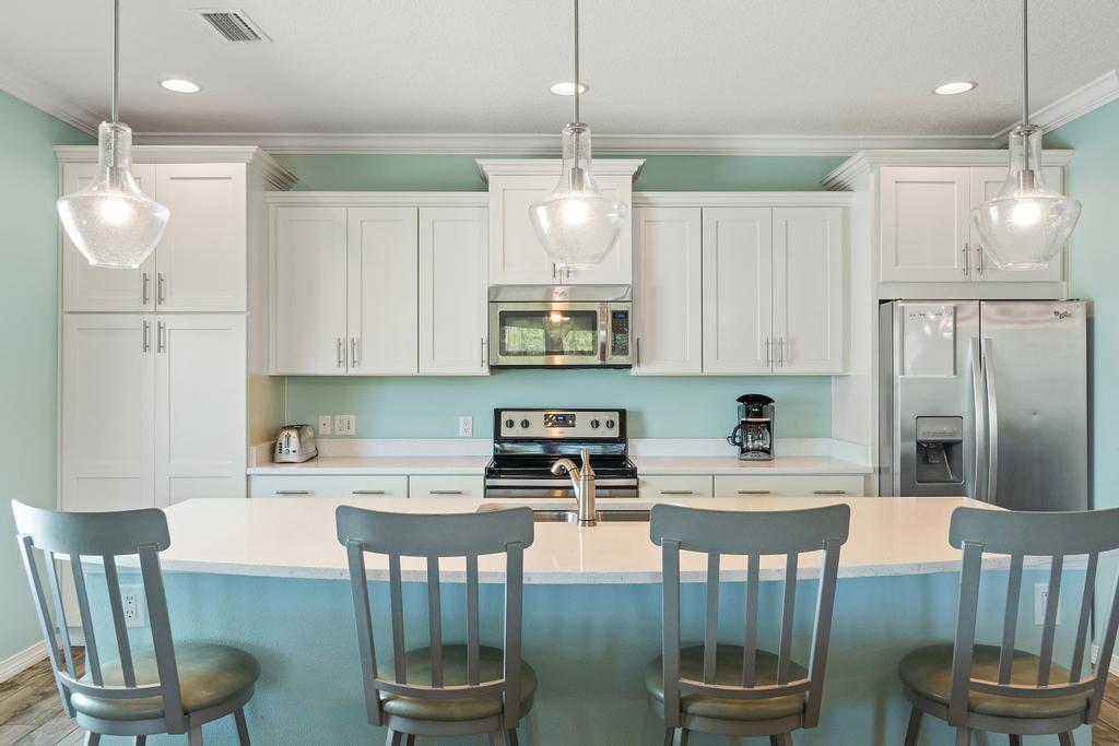 Kitchen with 8 foot island and four barstools