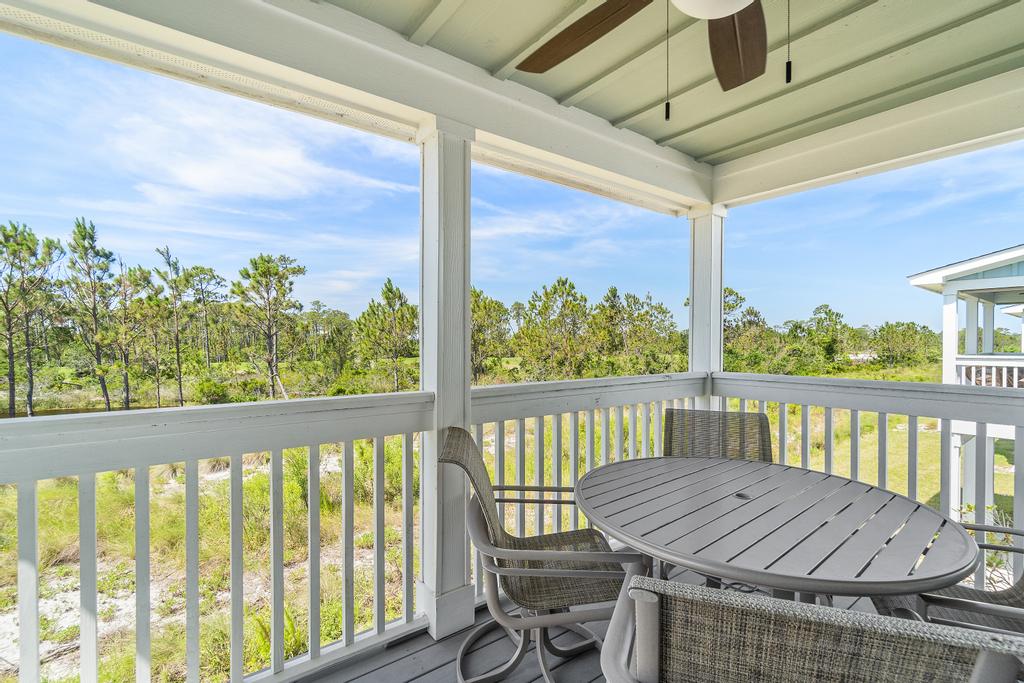 Covered back balcony overlooking trees and nature