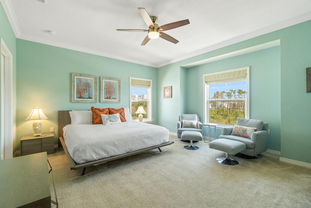 Primary bedroom with king bed and seating area