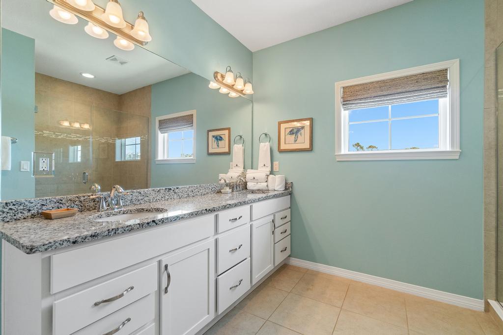 Primary bathroom with double sinks and walk-in shower