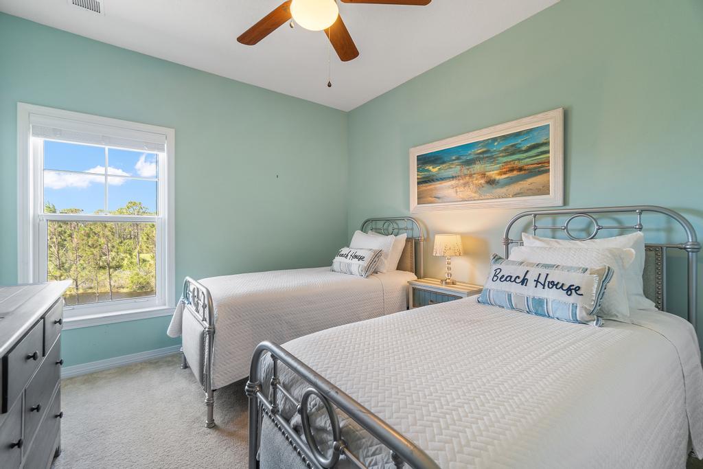 Twin bedroom with two twin beds and beach house decor